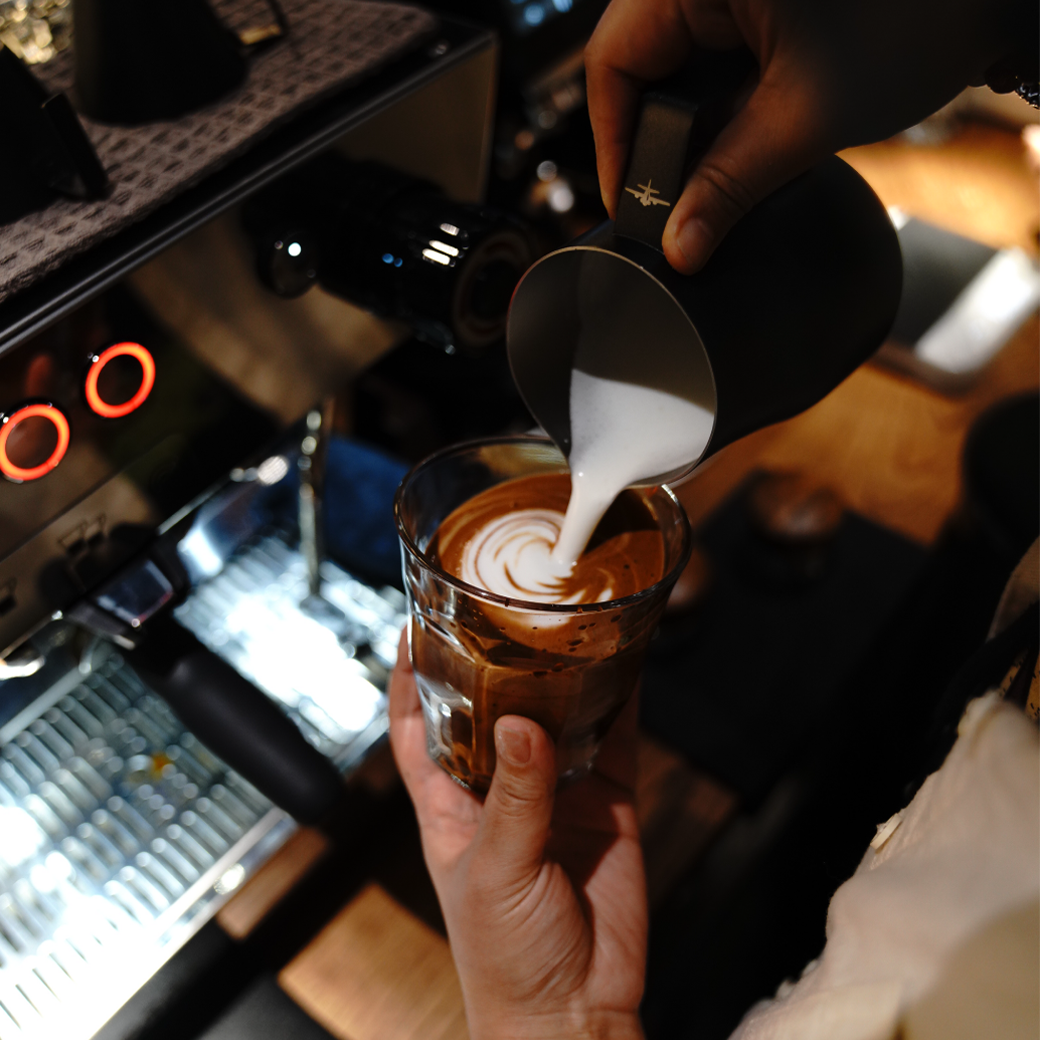 Barista pouring latte art